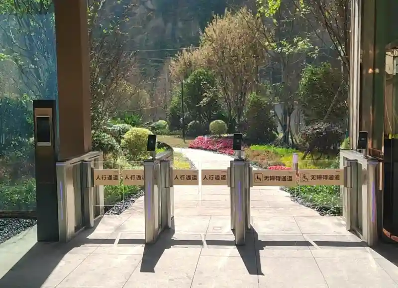 speed gate turnstile real case in residential community, swing barrier with face recognition device, includes normal pedestrian lane and handicap accessible lane